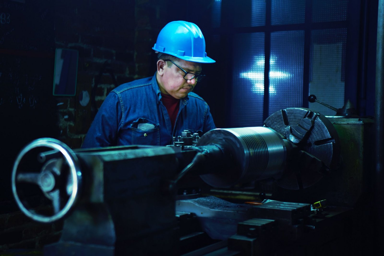An engineer supervising a machine component
